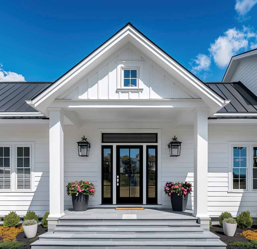 Entry door with sidelites and transom on a white farmhouse porch